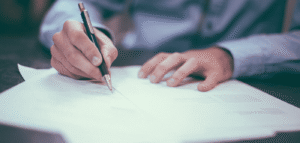 man filling out tax forms