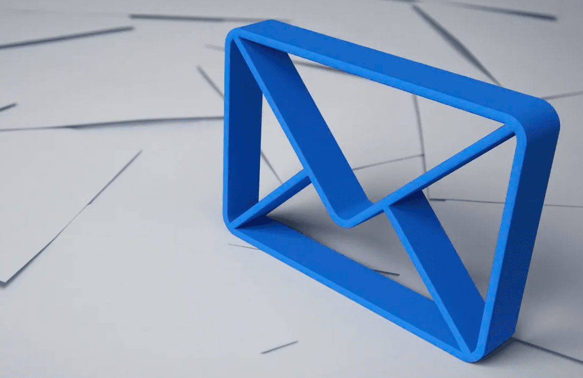 A three dimensional blue outline of an envelope standing on top of a mess of white envelopes